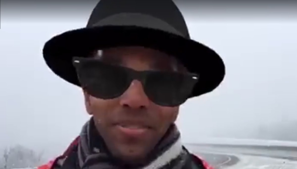 a reporter with a filter that gives him a hat and sunglasses